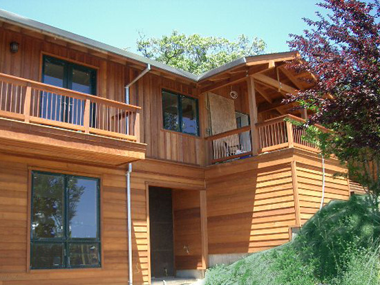 Redwood bevel siding on a rustic two storey home.