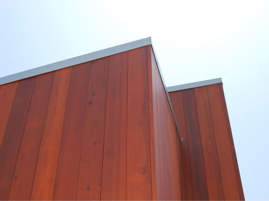 All heartwood redwood siding applied vertically.