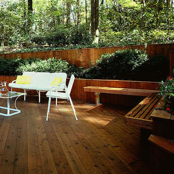 A beautiful redwood deck with built-in bench and retaining wall.